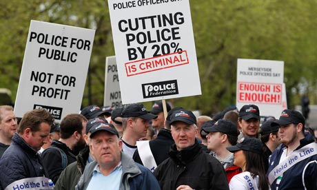 Police officers protesting against budget cuts join public sector workers striking over pensions